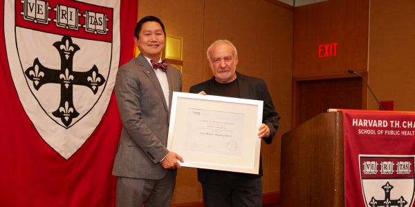 Wits Prof. Steve Tollman on right receives the Harvard Alumni Merit Award from Dr Bernard Lee Chair of Alumni Awards Committee